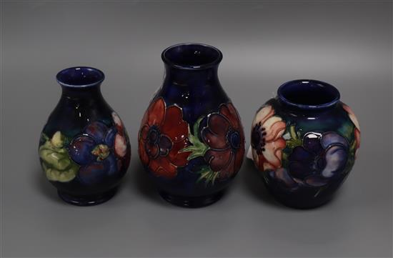 Three small Moorcroft Anemone pattern blue ground vases, H 13cm (tallest)